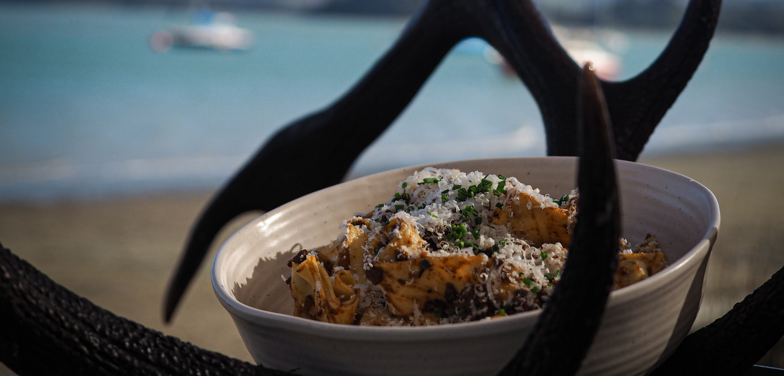 Bowl of food on a beach with ocean view
